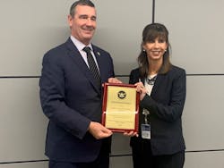 TSA Administrator David Pekoske presents a plaque to NFTA Executive Director Kim Minkel indicating that NFTA received the Gold Standard Award.