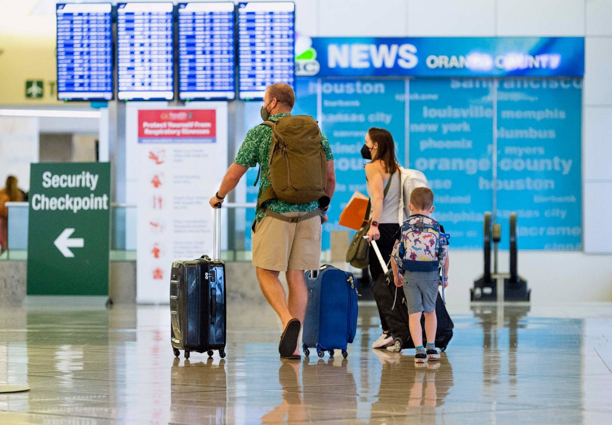 A family heads to the security check at John Wayne Airport in Santa Ana, CA on Wednesday, June 30, 2021. Free from most of the COVID-19 restrictions, many people are traveling and taking advantage of the long July 4th weekend.