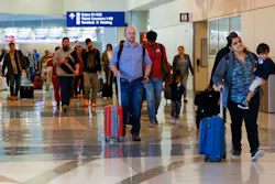 Travelers make their way to a security checkpoint inside Terminal D at DFW International Airport, Wednesday, March 1, 2023.