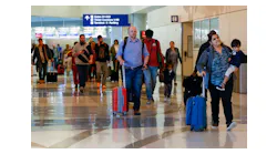 Travelers make their way to a security checkpoint inside Terminal D at DFW International Airport, Wednesday, March 1, 2023.