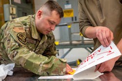 Tech. Sgt. Daniel Richards, a 934th Maintenance Squadron aircraft structural maintenance technician, applies a sticker for a sign onto sheet metal, at the Minneapolis-Saint Paul Air Reserve Station, Minnesota, May 6, 2023. ASM not only specializes in aircraft maintenance but with metal fabrication overall.