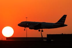 An American Airlines jet lands before the setting sun at Dallas/Fort Worth International Airport, Feb. 15, 2023.