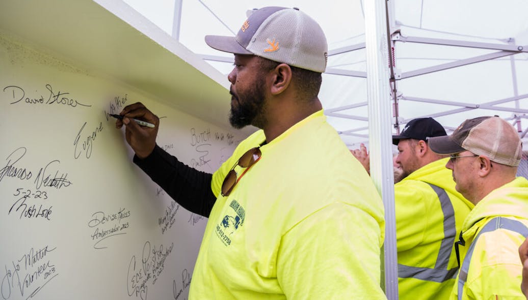 Eugene Walker, Heavy Equipment Operator for the Allegheny County Airport Authority, signs the final steel beam for the airport&rsquo;s new terminal structure.