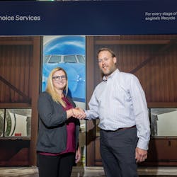 Nicole Tibbetts, Chief Manufacturing Engineer for MRO at GE Aerospace, and Michael Domke, General Manager Visual at Waygate Technologies, shake hands to mark the signing of the agreement.