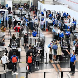 Airline passengers wait at a Transportation Security Administration (TSA) checkpoint to clear security before boarding to flights in the airport terminal in Denver on April 19, 2022.