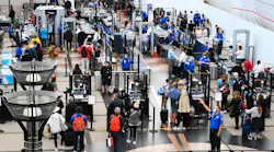 Airline passengers wait at a Transportation Security Administration (TSA) checkpoint to clear security before boarding to flights in the airport terminal in Denver on April 19, 2022.