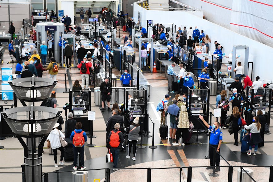 Airline passengers wait at a Transportation Security Administration (TSA) checkpoint to clear security before boarding to flights in the airport terminal in Denver on April 19, 2022.