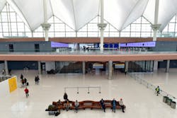 Travelers sit in part of the newly renovated areas on the 5th and 6th floor amid Phase 1 of terminal improvements on the $770 million Great Hall renovation project at Denver International Airport on Oct. 27, 2021, in Denver. The renovations created a more modern check-in experience and added capacity in the terminal as well as improving operational efficiency. Travelers sit in part of the newly renovated areas on the 5th and 6th floor amid Phase 1 of terminal improvements on the $770 million Great Hall renovation project at Denver International Airport on Oct. 27, 2021, in Denver. The renovations created a more modern check-in experience and added capacity in the terminal as well as improving operational efficiency.