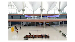 Travelers sit in part of the newly renovated areas on the 5th and 6th floor amid Phase 1 of terminal improvements on the $770 million Great Hall renovation project at Denver International Airport on Oct. 27, 2021, in Denver. The renovations created a more modern check-in experience and added capacity in the terminal as well as improving operational efficiency.