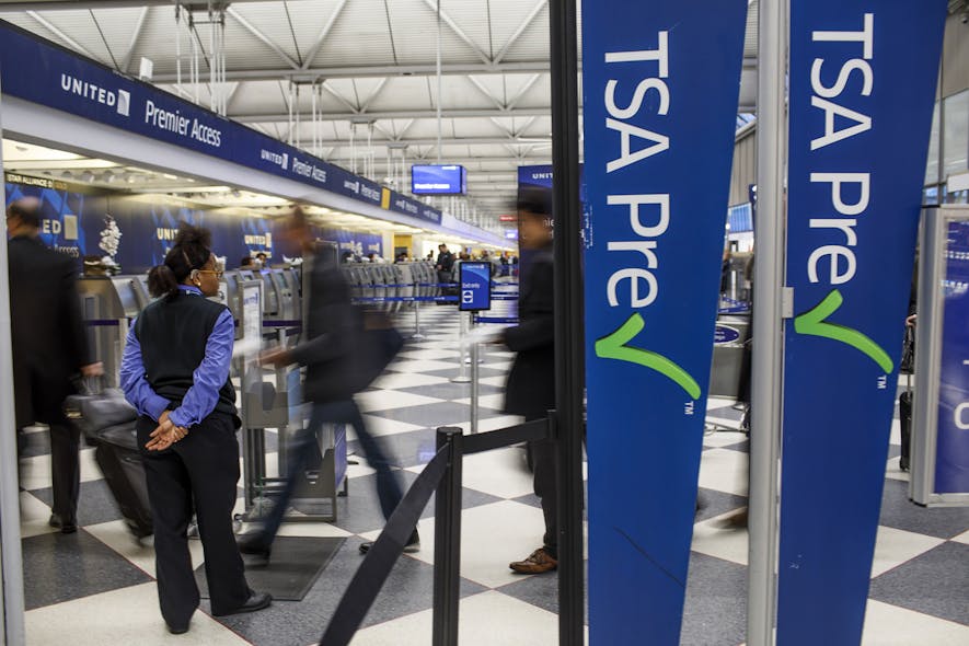 Passengers walk through the entrance of a TSA PreCheck in at O&apos;Hare International Airport in 2017 in Chicago.