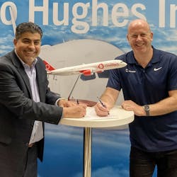 At the Hughes booth at the Airline Interiors Expo in Hamburg, Germany, Reza Rasoulian, vice president at Hughes, and Ben Griffin, vice president at OneWeb, sign the Distribution Partner agreement for Hughes to provide OneWeb Low Earth Orbit satellite connectivity services to global airlines and select partners.