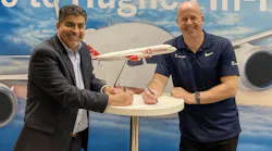 At the Hughes booth at the Airline Interiors Expo in Hamburg, Germany, Reza Rasoulian, vice president at Hughes, and Ben Griffin, vice president at OneWeb, sign the Distribution Partner agreement for Hughes to provide OneWeb Low Earth Orbit satellite connectivity services to global airlines and select partners.