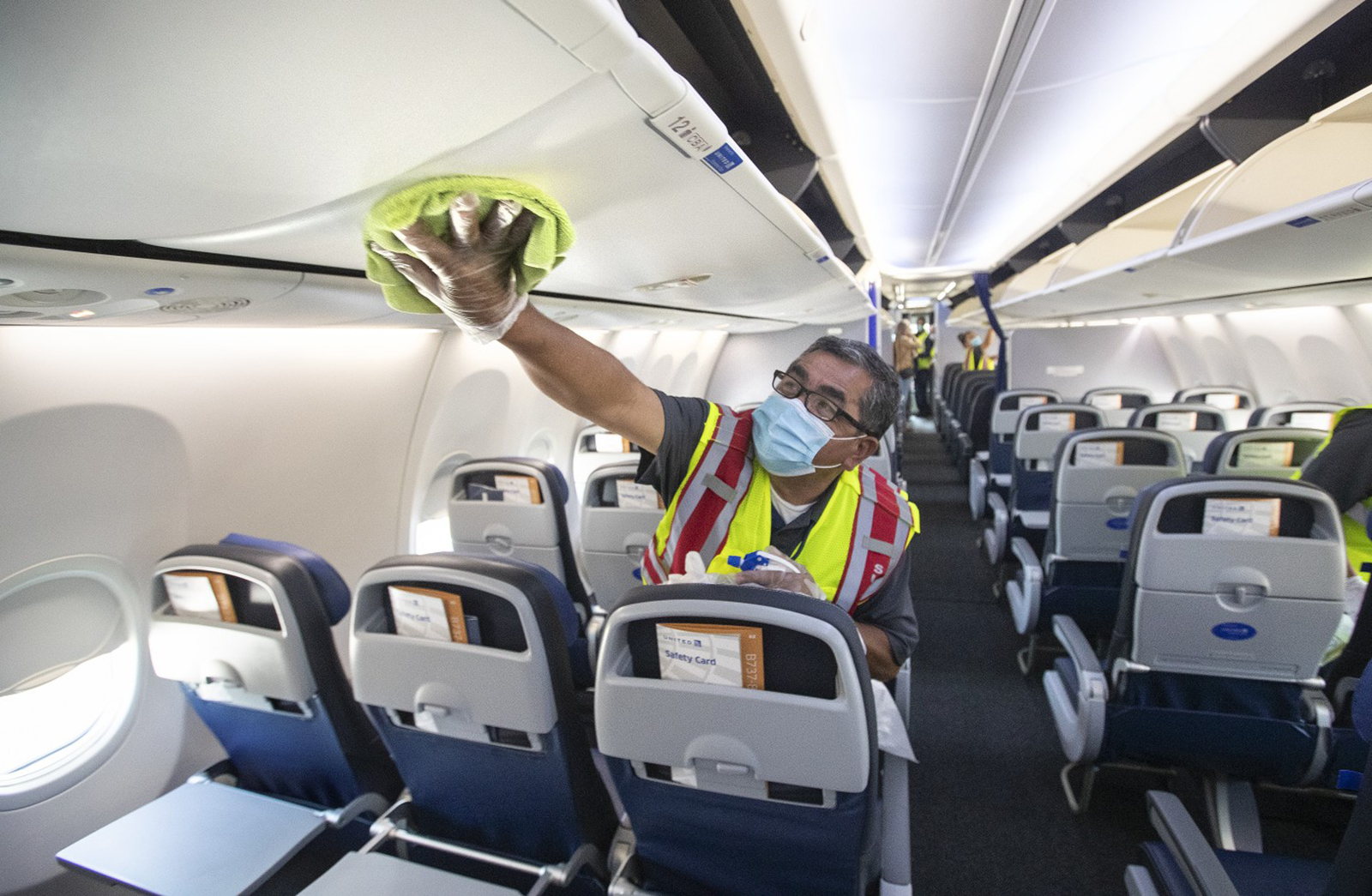 Cleaning supervisor Jose Mendoza disinfects a United Airlines jet cabin before passengers are allowed to board at LAX on July 9, 2020 in Los Angeles. Reauthorization of the FAA is one of the more pressing issues on the to-do list for Congress this summer.