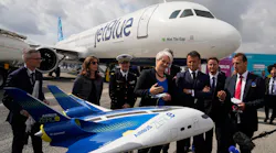 French President Emmanuel Macron, middle, and Airbus CEO Guillaume Faury, right, look at the concept hybrid-hydrogen aircraft Airbus Zero during the International Paris Air Show at the Paris-Le Bourget Airport on June 19, 2023.