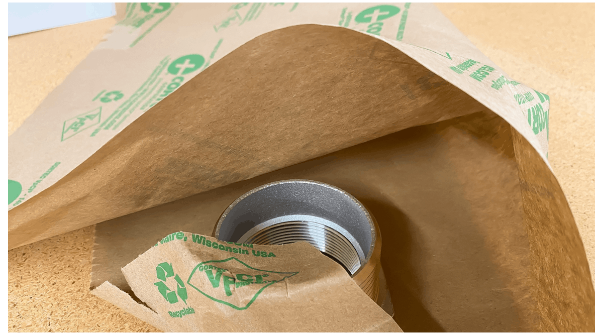 Corrosion inhibiting packaging in the form of VCI film or VCI paper allows metals to be stored or shipped in rust-free condition.