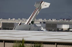 Long Beach, CA - A small plane sits with its tail up after crashing into a building at the Long Beach Airport on Monday, July 10, 2023. July 10: in Long Beach on Monday, July 10, 2023 in Long Beach, CA. Long Beach, CA - A small plane sits with its tail up after crashing into a building at the Long Beach Airport on Monday, July 10, 2023. July 10: in Long Beach on Monday, July 10, 2023 in Long Beach, CA.