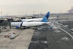 Two United Airlines jets are seen at Newark Airport's Terminal B. The airline will be the first to equip it's entire mainline fleet with Braille seat markers and other signs to help passengers.