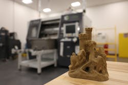A model sandcastle sits on a table in front of an ExOne S-Print sand 3D printer at Tinker Air Force Base, Okla., April 13, 2023. The 76th Commodity Maintenance Group’s new foundry can sand cast aluminum parts up to 120 pounds, providing another avenue for sourcing aircraft parts not easily obtained through traditional contracting methods. A model sandcastle sits on a table in front of an ExOne S-Print sand 3D printer at Tinker Air Force Base, Okla., April 13, 2023. The 76th Commodity Maintenance Group’s new foundry can sand cast aluminum parts up to 120 pounds, providing another avenue for sourcing aircraft parts not easily obtained through traditional contracting methods.
