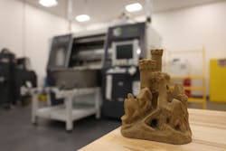 A model sandcastle sits on a table in front of an ExOne S-Print sand 3D printer at Tinker Air Force Base, Okla., April 13, 2023. The 76th Commodity Maintenance Group&rsquo;s new foundry can sand cast aluminum parts up to 120 pounds, providing another avenue for sourcing aircraft parts not easily obtained through traditional contracting methods.