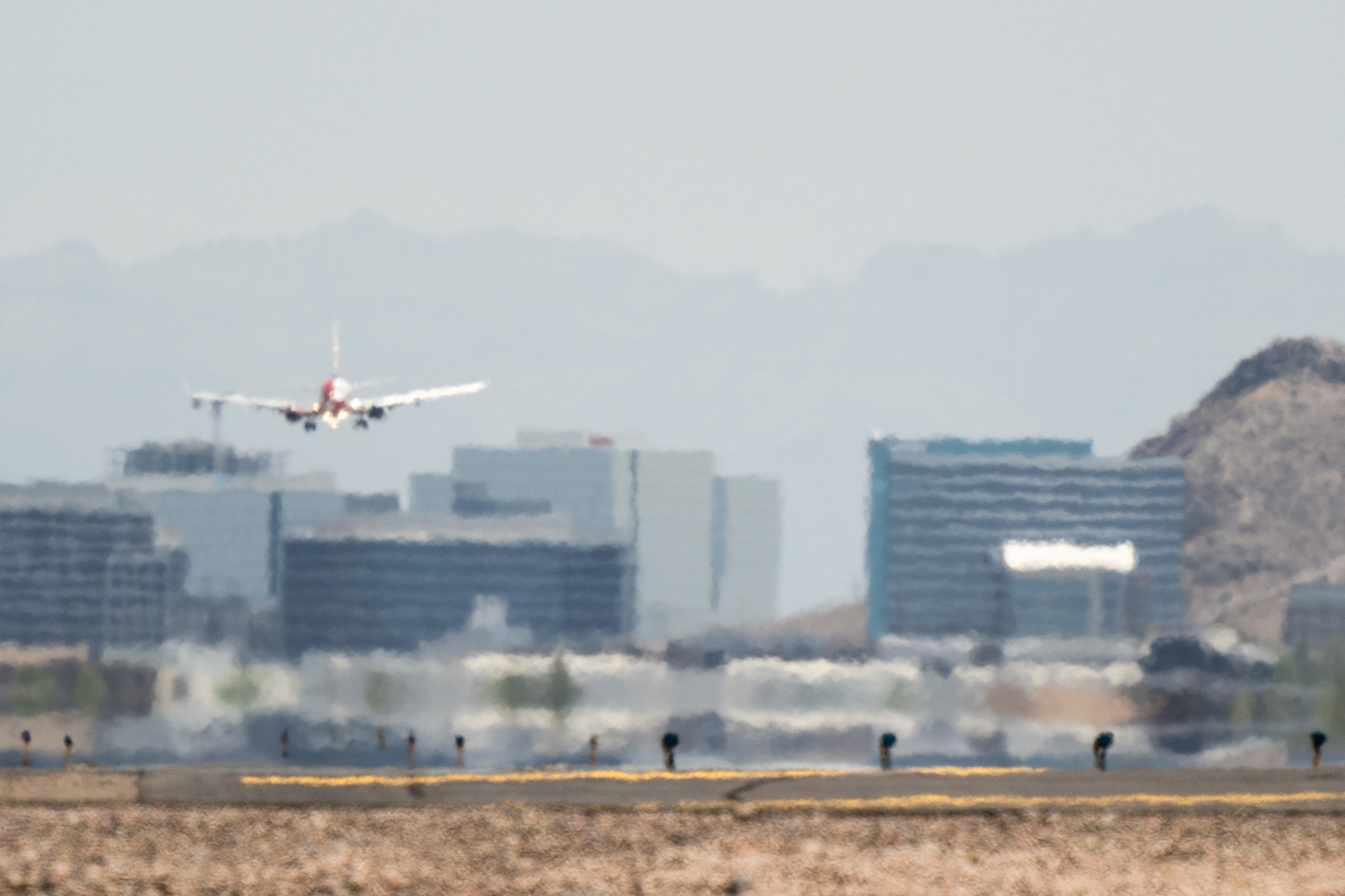 An airplane approaches the runway at the Phoenix Sky Harbor International Airport during a heat wave on July 15, 2023, in Phoenix. Weather forecasts today are expecting temperatures to reach 115 degrees. The Phoenix area is grappling with record-breaking temperatures as prolonged heat waves continue soaring across the Southwest.