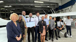 Boeing leaders present a check to Fly Compton. Funds will increase flight training classes offered to students in L.A.'s Compton community and introduce career topics related to designing, building and maintaining airplanes and drones.