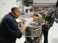 Joe Sabatini, at left, is shown performing a hot section inspection on a J85-5H engine in support of the experimental side of the house.