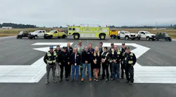 In California, the County of Humboldt's Department of Aviation staff gather on the freshly repaved runway at the California Redwood Coast-Humboldt County Airport.
