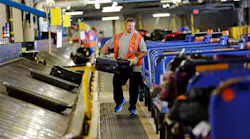 Southwest Airlines ramp agent Matt Lockby carries luggage in the baggage sorting area at Dallas Love Field Airport Thursday, October 2, 2014 in Dallas.