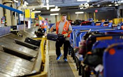 Southwest Airlines ramp agent Matt Lockby carries luggage in the baggage sorting area at Dallas Love Field Airport Thursday, October 2, 2014 in Dallas. Southwest Airlines ramp agent Matt Lockby carries luggage in the baggage sorting area at Dallas Love Field Airport Thursday, October 2, 2014 in Dallas.