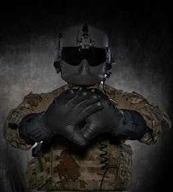 Staff Sgt. Dylan Metcalf, 54th Helicopter Squadron flight engineer, poses with a pair of heated glove prototypes being tested by Minot Air Force Base, N.D., July 28, 2023. The 54th HS can work up to approximately 10,000 feet where temperatures can be extremely low, requiring the highest level of cold-weather equipment to stay warm and offset hypothermia.