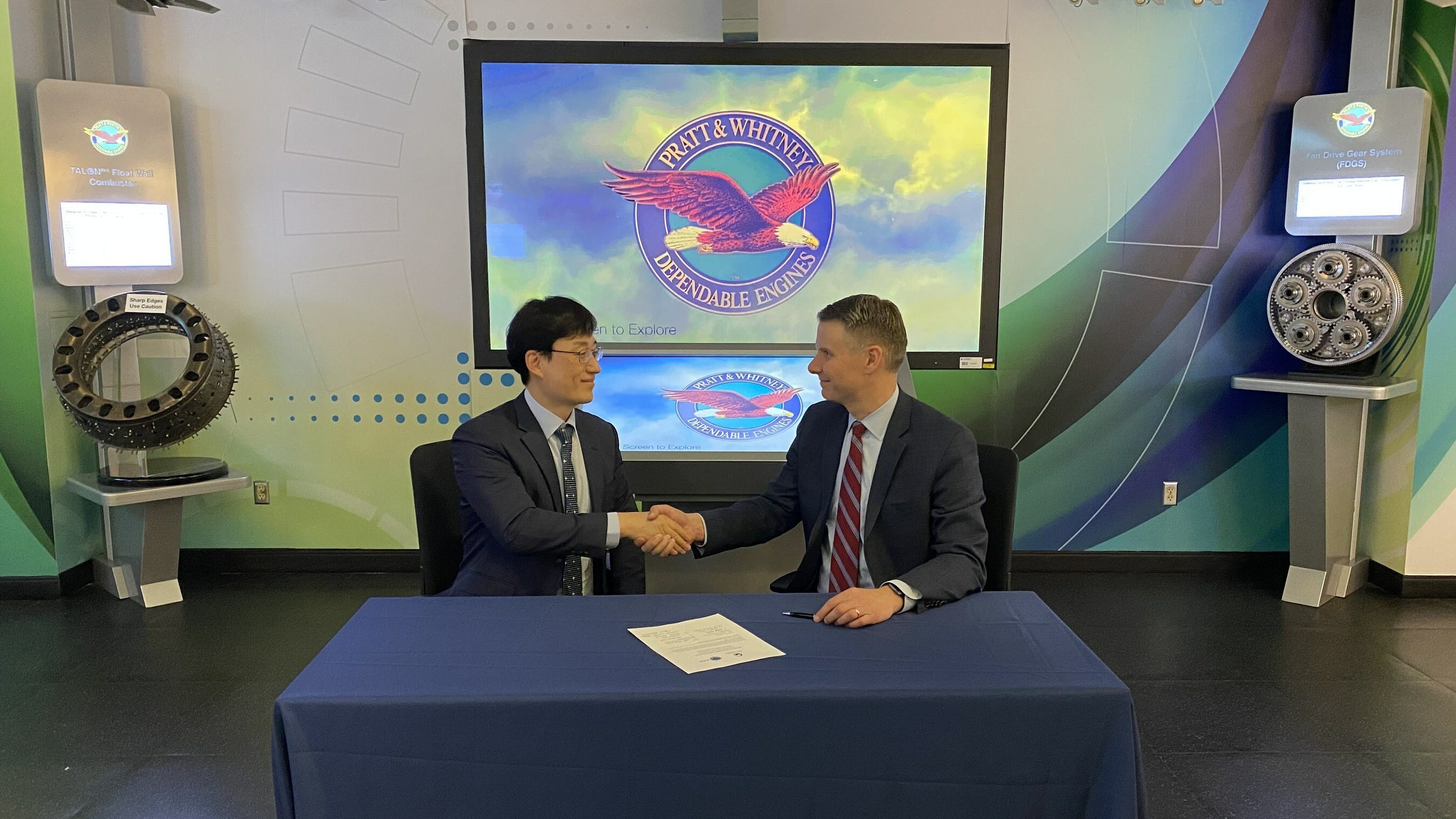 Chris Johnson, vice president of Fighter and Mobility Programs at Pratt & Whitney (right), and Director General Lee Gui-Hyun (left) sign the third consecutive performance-based logistics contract that Pratt & Whitney and DAPA have signed since 2012, offering on-going maintenance support for the Republic of Korea Air Force&rsquo;s F-15 Eagles and F-16 Fighting Falcons.
