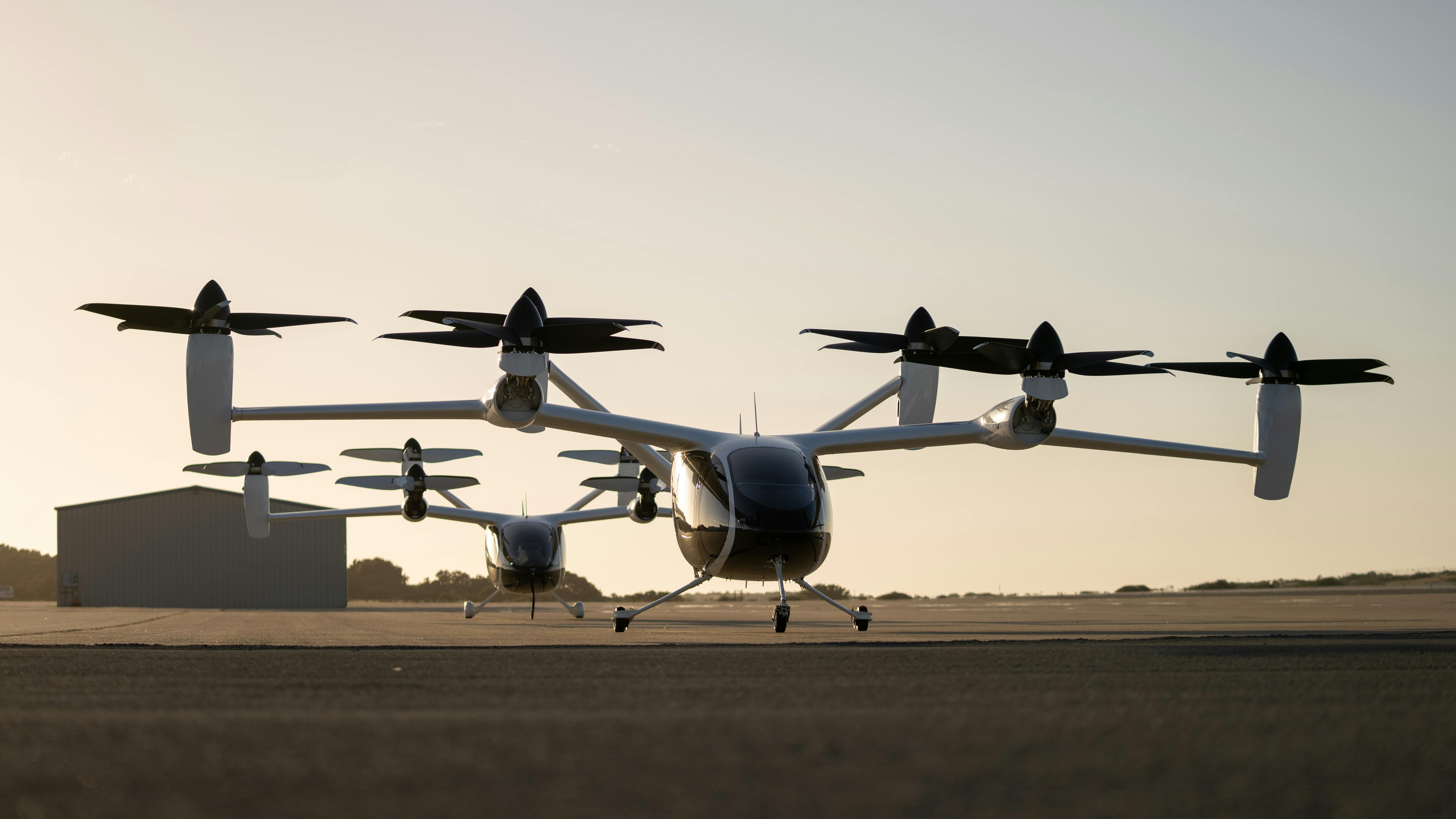 Two of Joby&rsquo;s prototype electric air taxi aircraft at the company&rsquo;s flight test and manufacturing facilities in Marina, California.