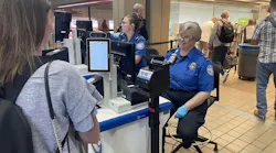 A traveler waits while the tablet captures her photo to immediately verify that her face matches the face on her ID.