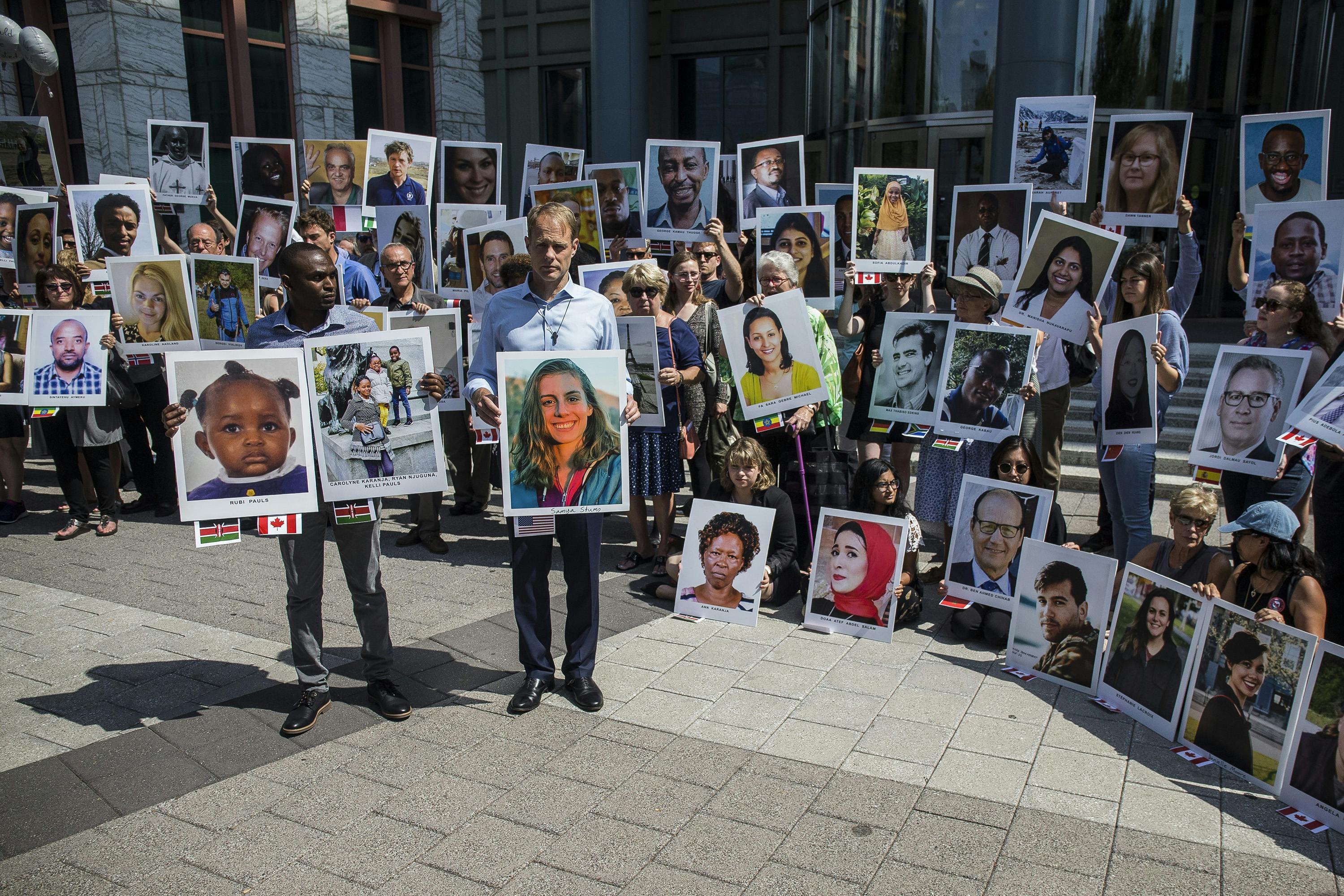 People hold signs during a vigil for victims of the Ethiopian Airlines Flight ET302 crash on Sept. 10, 2019, in Washington, D.C. The March 10, 2019, crash killed 157 people.