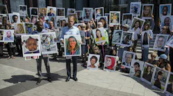People hold signs during a vigil for victims of the Ethiopian Airlines Flight ET302 crash on Sept. 10, 2019, in Washington, D.C. The March 10, 2019, crash killed 157 people.