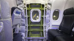 A panel has been removed that covered the door plug on a Boeing 737-9 Max parked near an Alaska Airlines hangar at SEA on Jan. 11, 2024. Four bolts and 12 stop fittings hold the door plug in place.