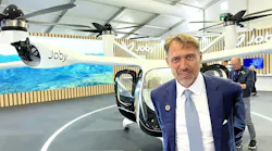 Joby Aviation founder and CEO JoeBen Bevirt with a mockup of the company’s air taxi at the 2024 Farnborough Air Show.