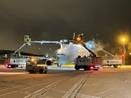 Removing ice from aircraft involves careful movement of machinery and personnel with caution during hostile outdoor conditions. Removing ice from aircraft involves careful movement of machinery and personnel with caution during hostile outdoor conditions.