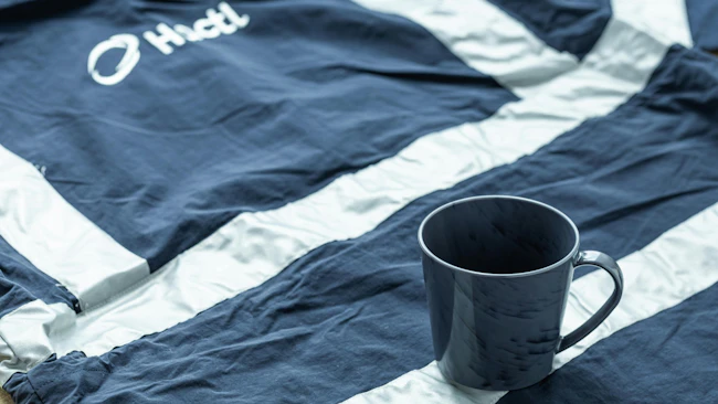 Hactl transformed old staff uniforms into 5,000 upcycled cups, marking Hong Kong's aviation industry's first zero-waste upcycling project for old clothing.