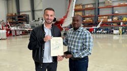 Left to right: Michael Axtmann, Managing Director, FAI Technik, receives the AMO certificate from Toks Fadairo, Aviation Safety Inspector, NCAA.