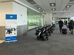 A row of autonomous wheelchairs ready for use at an airport. These devices are part of an automated mobility service designed to enhance passenger independence and optimize airport operations. A row of autonomous wheelchairs ready for use at an airport. These devices are part of an automated mobility service designed to enhance passenger independence and optimize airport operations.