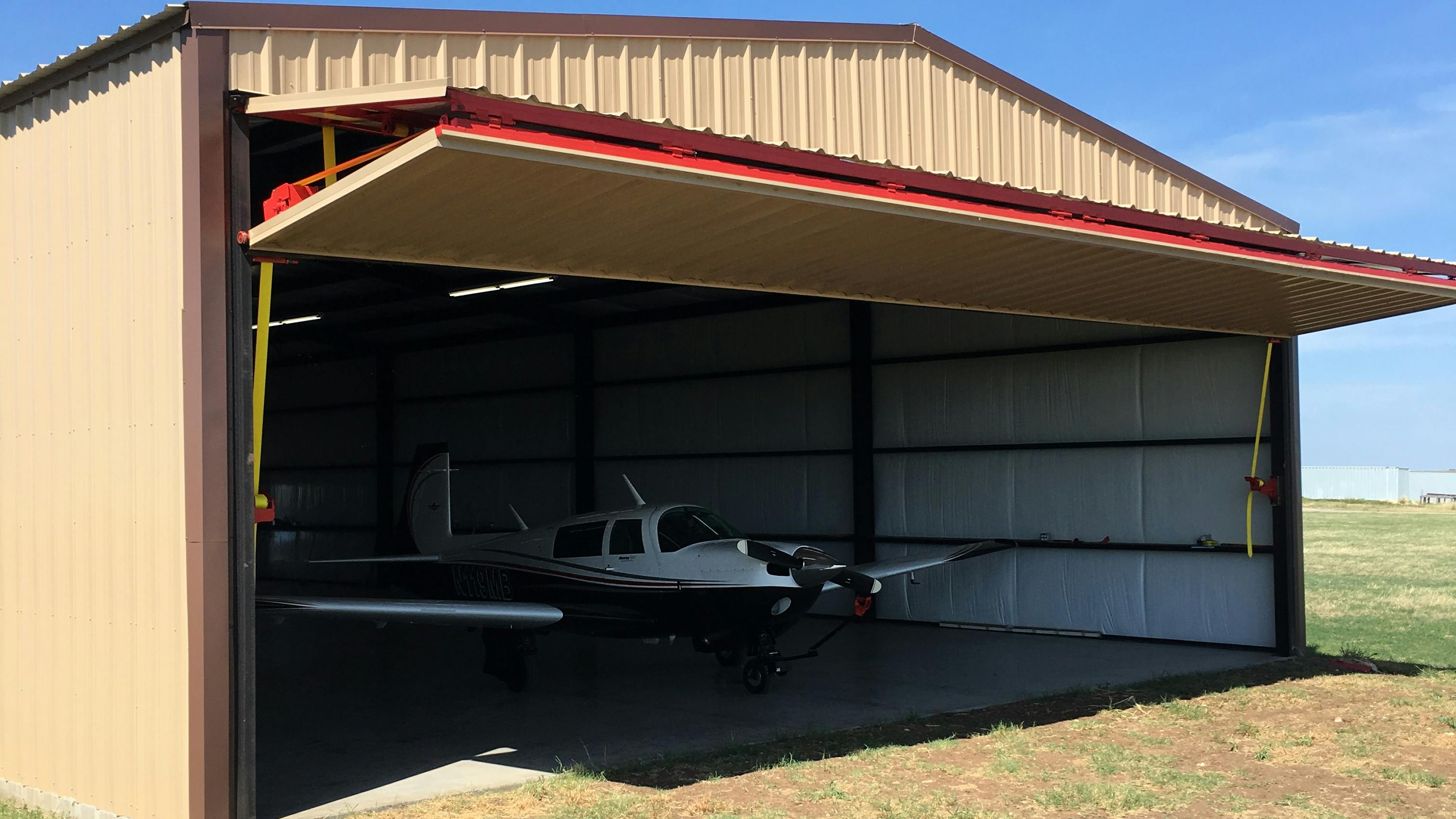 Mike Wagner&rsquo;s Mooney M20J fits nicely in his new 42-foot by 84-foot hangar equipped with a 40-foot by 14-foot Schweiss Doors bifold liftstrap door. When opened the bifold door provides a shaded canopy for the hangar.