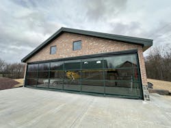 Don Smith Jr.’s new hangar at his property in Pennsylvania is a unique structure with its glass covered Schweiss Doors hydraulic door, painted green to match the roof and window trim of the building.