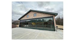 Don Smith Jr.’s new hangar at his property in Pennsylvania is a unique structure with its glass covered Schweiss Doors hydraulic door, painted green to match the roof and window trim of the building. Don Smith Jr.’s new hangar at his property in Pennsylvania is a unique structure with its glass covered Schweiss Doors hydraulic door, painted green to match the roof and window trim of the building.