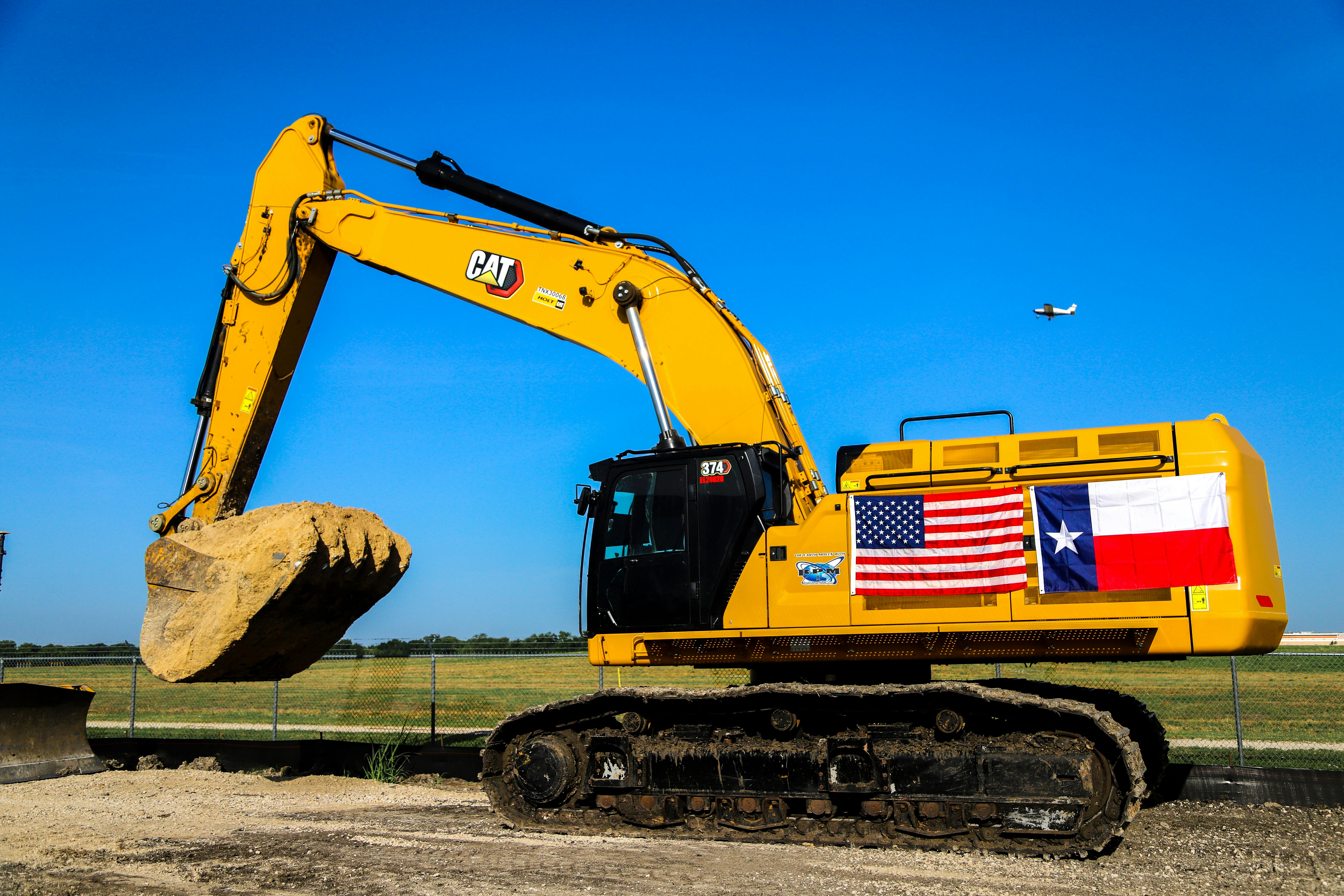 mckinney_mayor_bill_cox_drops_dirt_from_an_excavat