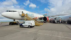 An airplane with the logo for YunExpress sits on the tarmac with a yellow mobile staircase attached and a cargo van in front An airplane with the logo for YunExpress sits on the tarmac with a yellow mobile staircase attached and a cargo van in front