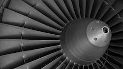A close-up shot shows an aircraft engine's turbine A close-up shot shows an aircraft engine's turbine