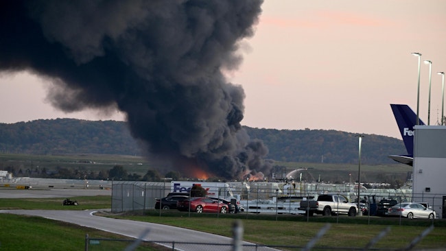 Fire and smoke mark where a UPS cargo plane crashed near Louisville Muhammad Ali International Airport on Tuesday, Nov. 4, 2025, in Louisville, Kentucky. The fully fueled plane crashed shortly after takeoff, with a shelter-in-place order issued for within 5 miles of the airport. (Stephen Cohen/Getty Images/TNS)