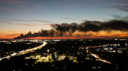 Smoke rises from the site of a UPS cargo plane crash near the UPS Worldport at Louisville Muhammad Ali International Airport in Louisville, Kentucky, on Nov. 4, 2025. (Leandro Lozada/AFP/Getty Images/TNS)