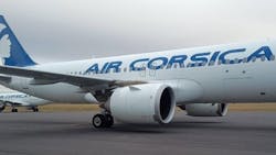 A white airplane with a blue fin and blue lettering that says 'Air Corsica' A white airplane with a blue fin and blue lettering that says 'Air Corsica'